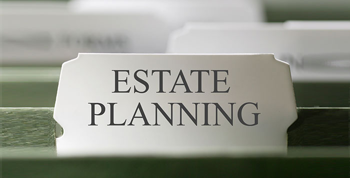A label reading 'ESTATE PLANNING' on a file folder in a filing system.