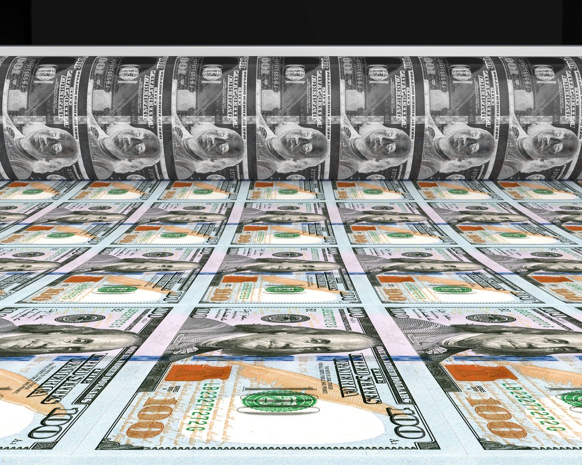 A close-up view of printed U.S. hundred-dollar bills in a stack.